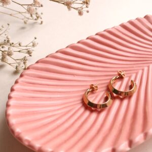 gold and silver rings on pink and white striped textile